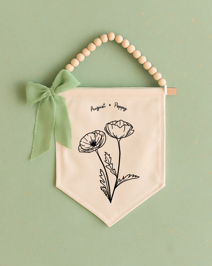 A banner with a floral design and a green ribbon is displayed against a green background.