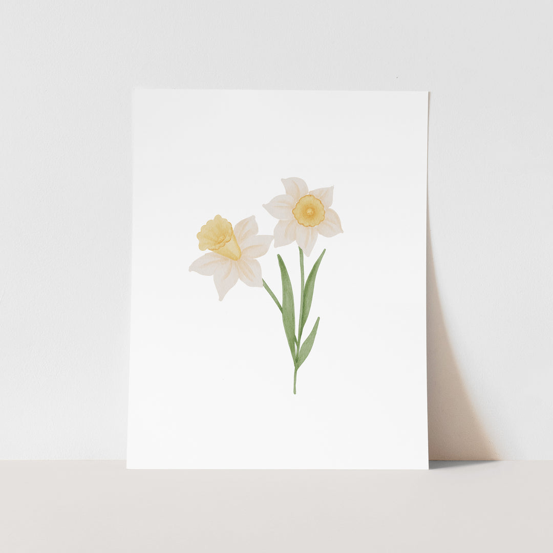 A white square card with a simple illustration of two white daffodils with yellow centers.