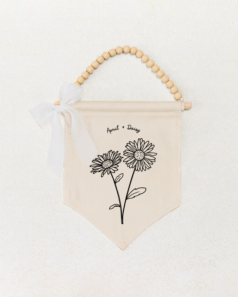 a beige banner with a floral design and a ribbon bow.
