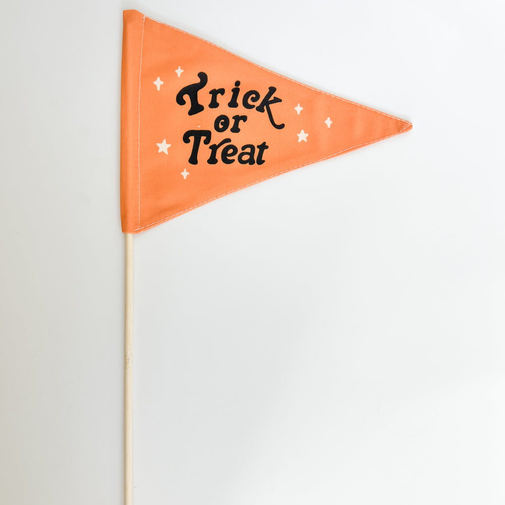 Orange triangle flag with 'Trick or Treat' text on a white background